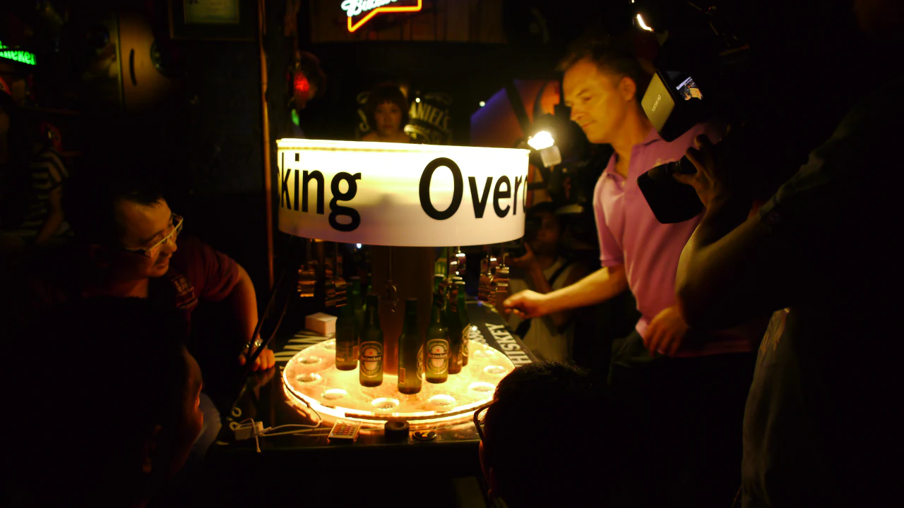 Crew gathered around an illuminated Overclocking installation during a night shoot